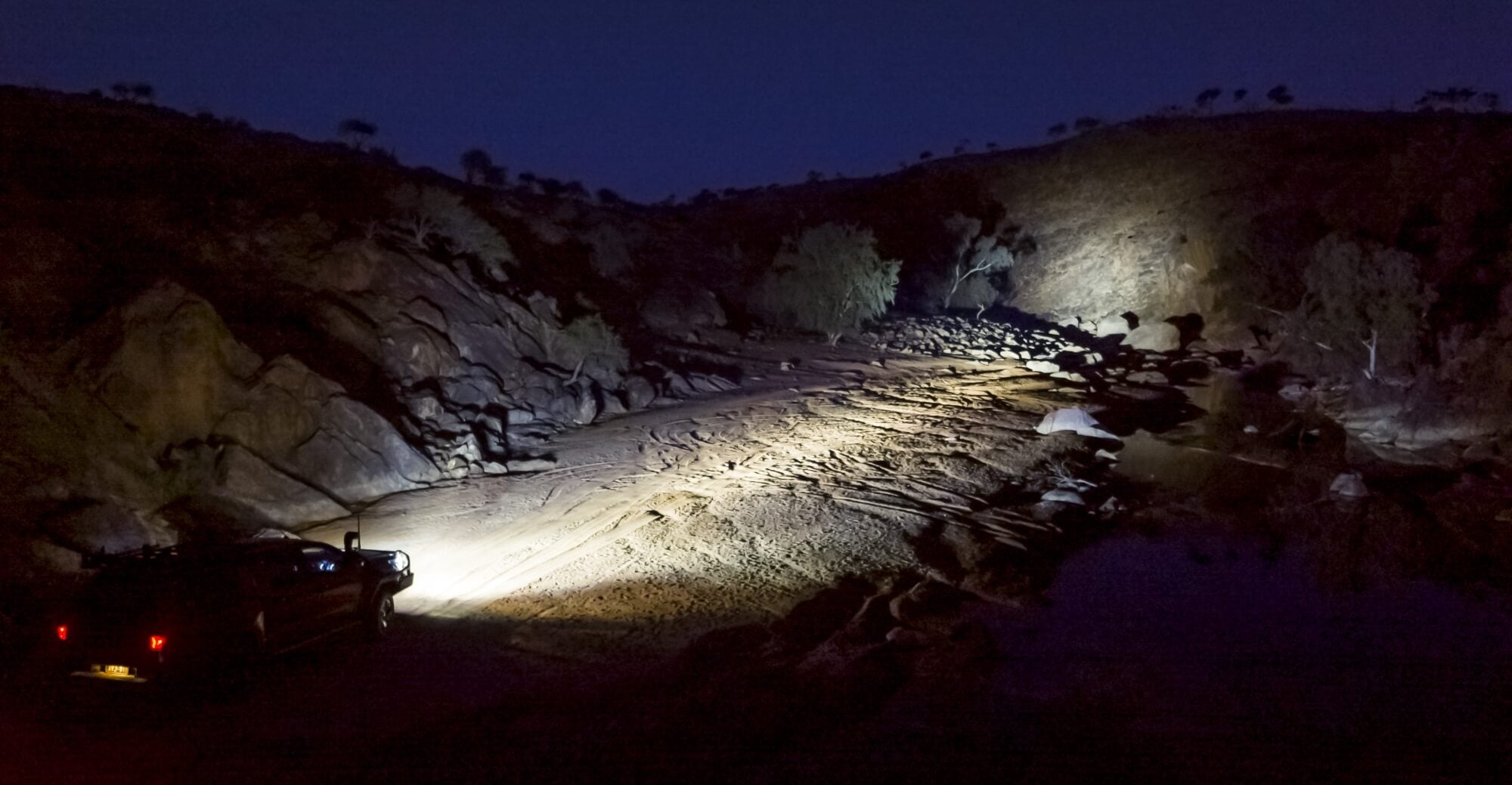 ARB Toyota Hilux Rouge at night showing the combined throw of light from the Intensity Solis Spot and Foreground range from the Intensity Solis Flood.