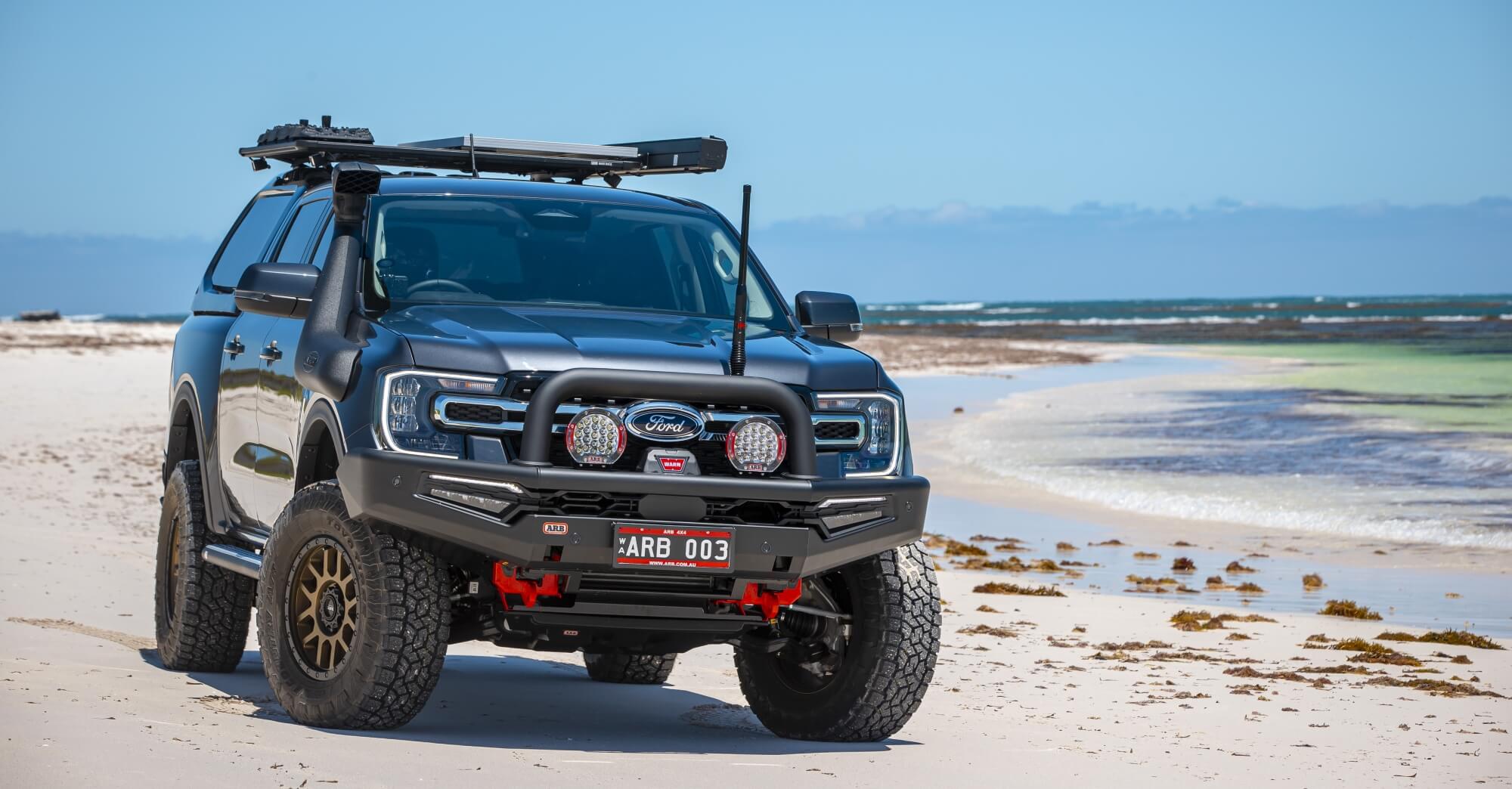 ARB Ford Ranger on a beach with ARB Intensity Solis 21 driving lights mounted on black Summit Sahara MKII bull bar
