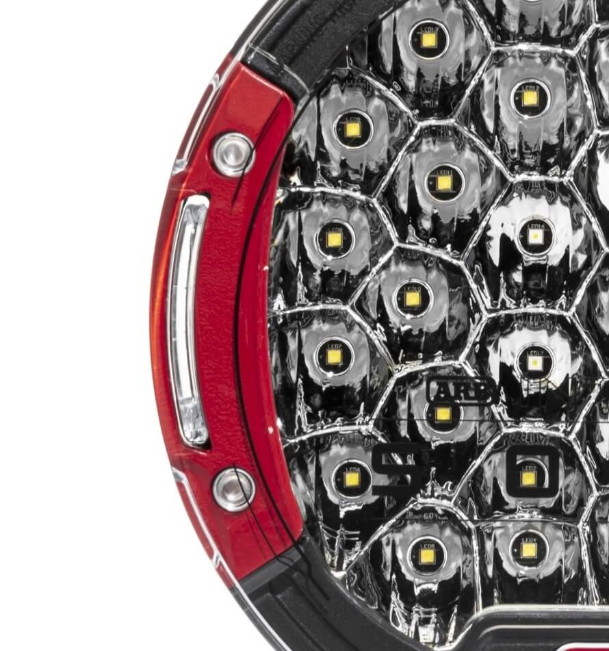 ARB Solis 21 Flood Driving Light close up showcasing red bezels and high performance LEDs